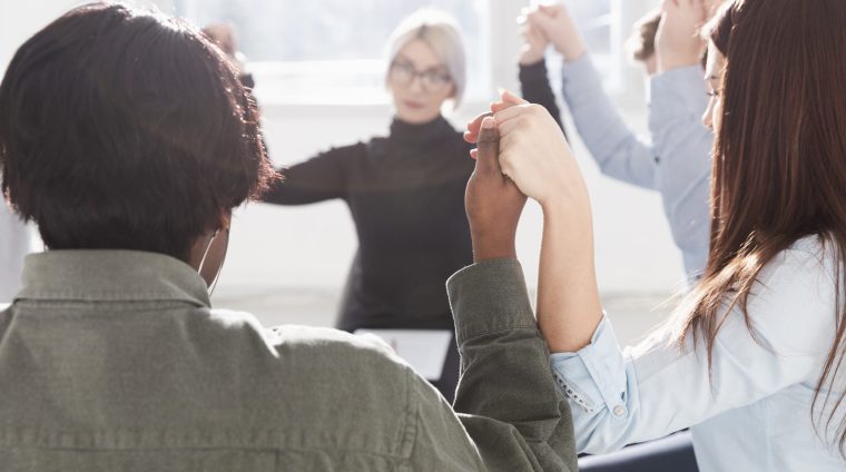 people-forming-circle-raising-hands