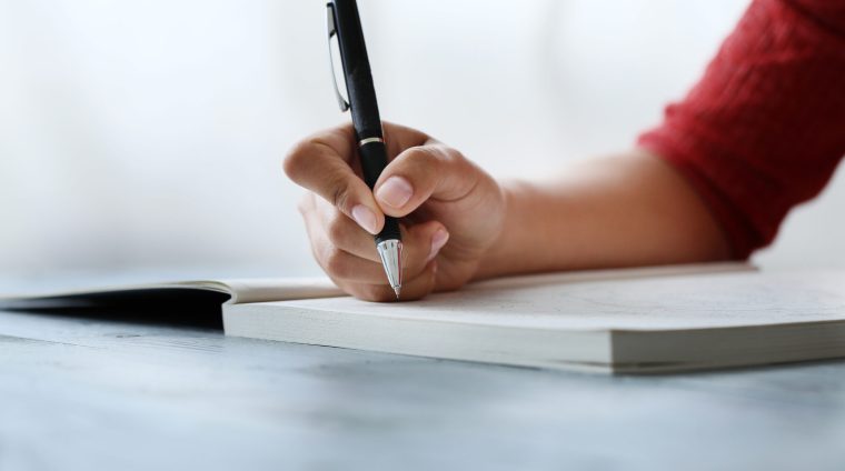 Notes. Woman holding a pen